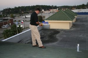 John Minor using thermal imaging on a commercial roof